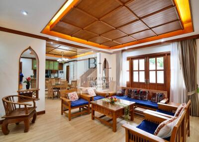 Spacious living room with wooden decor and large windows