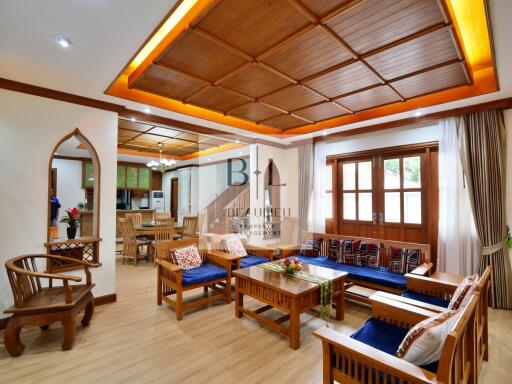 Spacious living room with wooden decor and large windows