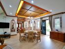 Spacious living and dining area with wooden decor and ceiling lights.