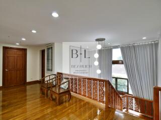 Spacious landing area with wooden flooring and intricate banisters