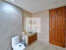 Modern bathroom with wooden door and large mirror