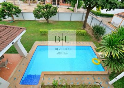 Beautiful outdoor pool with surrounding garden and greenery