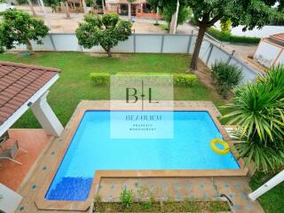 Beautiful outdoor pool with surrounding garden and greenery