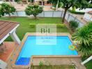 Beautiful outdoor pool with surrounding garden and greenery