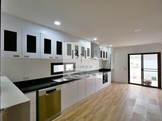 Modern kitchen with white cabinets and appliances