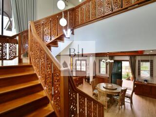 Elegant living room with intricate wooden staircase