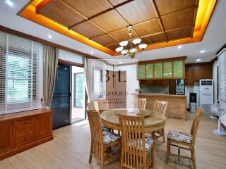 Spacious dining area with wooden ceiling and furnishings