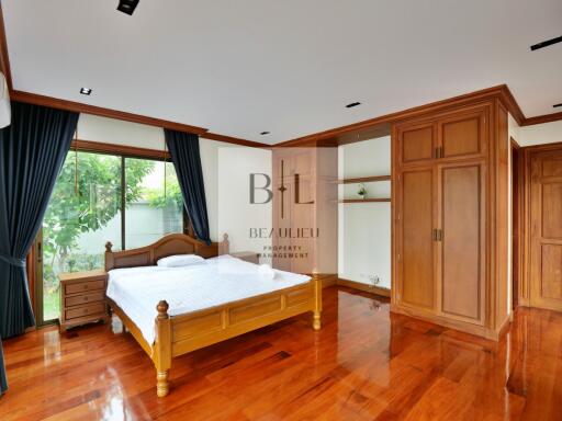 Spacious bedroom with wooden flooring