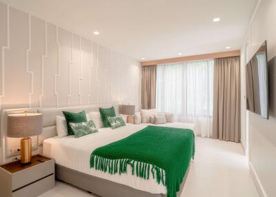Modern bedroom with green accents and large window