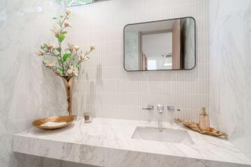 Modern bathroom with marble countertop and decorative elements