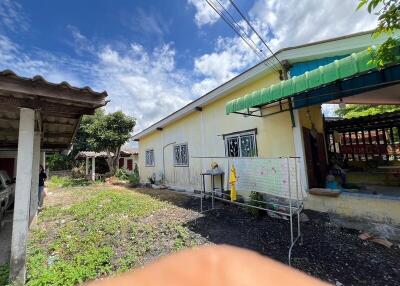 Exterior view of single-story house with yard