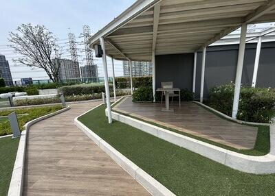 Covered outdoor area with a pathway and vegetation