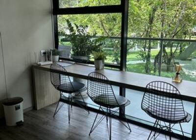 Modern dining area with large windows and bar seating