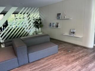 Modern living area with gray seating and wall-mounted shelves