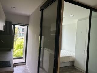 View of kitchen, bedroom, and balcony with sliding doors