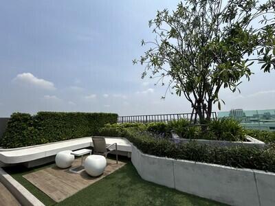 Outdoor terrace with seating area and greenery