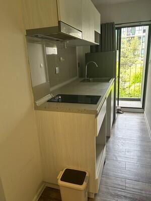 Modern kitchenette with a sink and cabinets