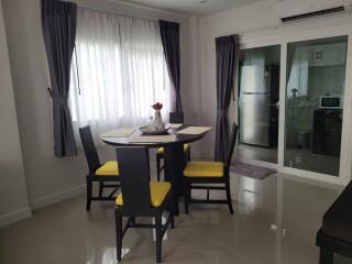 Modern dining area with a round table and four chairs