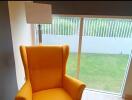 Bright corner with a yellow armchair and large window