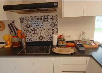 Modern kitchen with colorful backsplash and countertop appliances