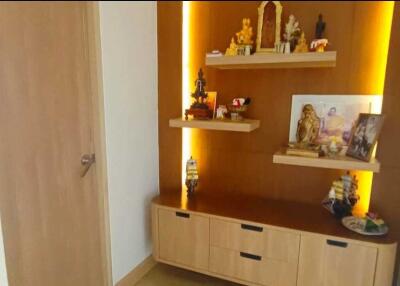 Prayer room with wooden shelves and religious idols