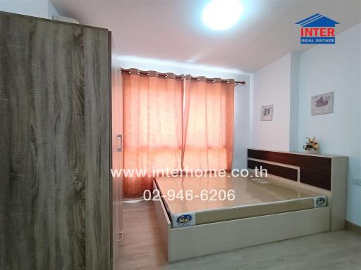 Bedroom with curtains and wooden furniture