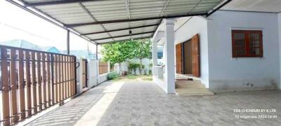 Covered outdoor area with gate and garden view