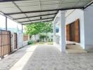 Covered outdoor area with gate and garden view