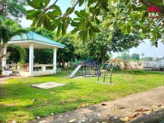 Outdoor playground next to a pavilion in a spacious yard