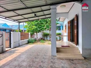 Covered patio and entrance with tile flooring and garden view