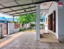 Covered patio and entrance with tile flooring and garden view