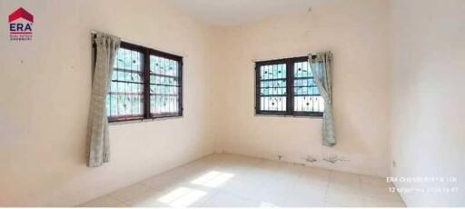 Spacious bedroom with two windows and natural light