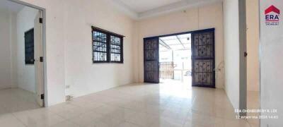 Spacious living room with large windows and double doors