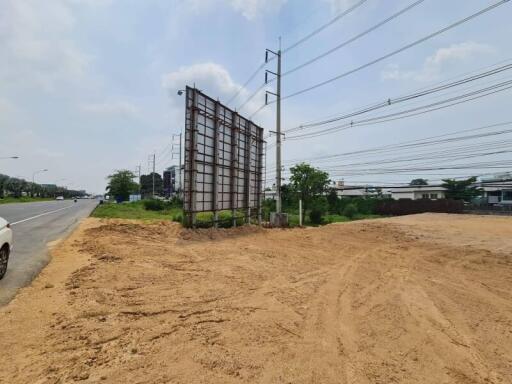 Empty land plot with a billboard on a sunny day