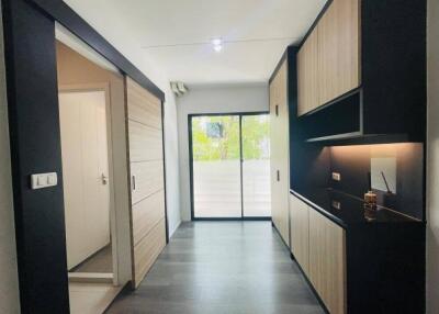 Modern minimalist kitchen with sliding door and ample storage