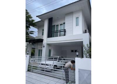 Modern two-story house with garage and front gate