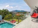 Scenic balcony view with modern furniture and swimming pool