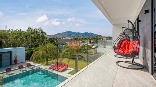 Scenic balcony view with modern furniture and swimming pool