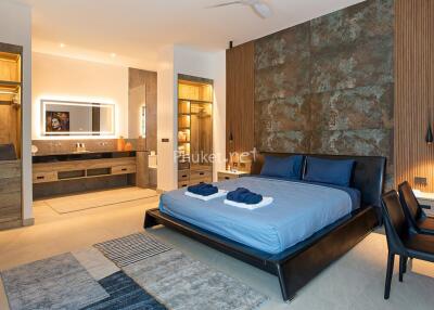 Spacious modern bedroom with a luxurious bed, en-suite bathroom, and sophisticated decor