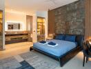 Spacious modern bedroom with a luxurious bed, en-suite bathroom, and sophisticated decor