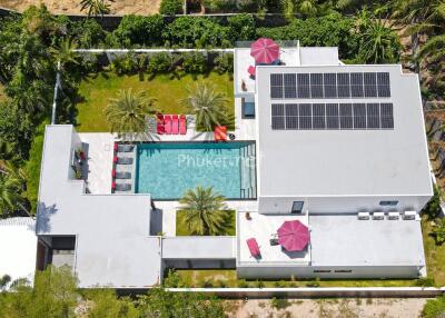 Aerial view of modern house with swimming pool and solar panels