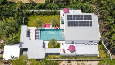 Aerial view of modern house with swimming pool and solar panels