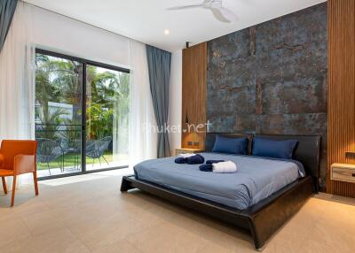 Spacious modern bedroom with large window and outdoor view