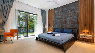 Spacious modern bedroom with large window and outdoor view