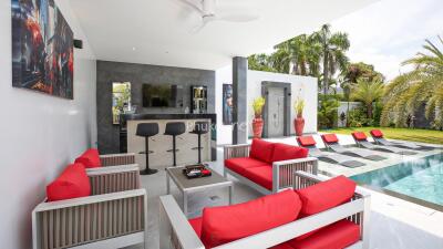 Outdoor seating area with pool and bar