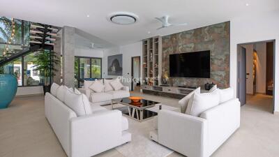 Modern living room with contemporary furnishings and a wall-mounted TV