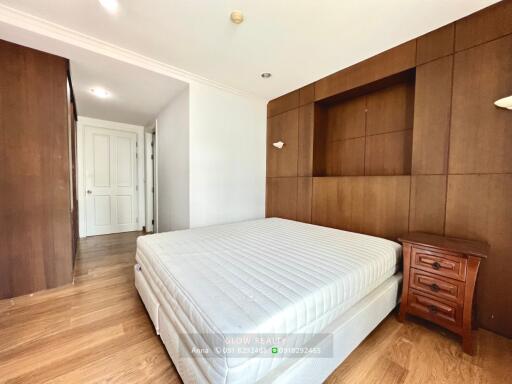 Bedroom with wooden panel wall and large bed