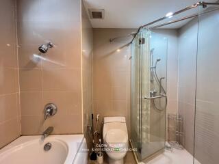 Modern bathroom with a bathtub and glass-enclosed shower