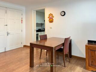 Dining area with table and two chairs next to a kitchen entrance