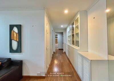 Spacious hallway with wooden flooring and built-in shelving